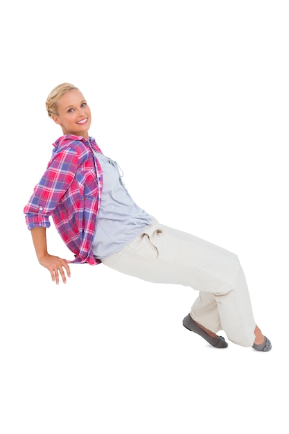 Blonde sitting and smiling at camera