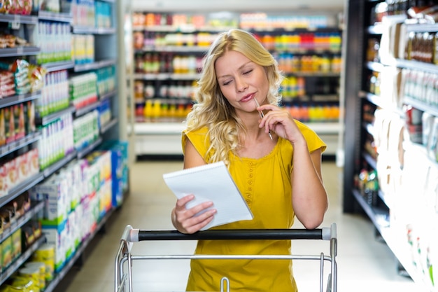 Blonde smiling woman checking list