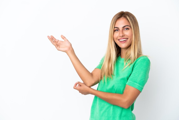 Blonde Uruguayan girl isolated on white background extending hands to the side for inviting to come