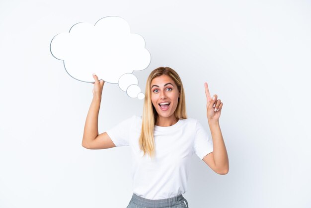 Blonde Uruguayan girl isolated on white background holding a thinking speech bubble