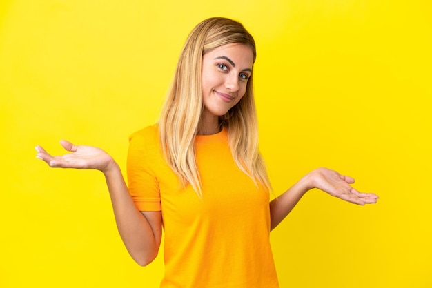 Blonde uruguayan girl isolated on yellow background happy and smiling