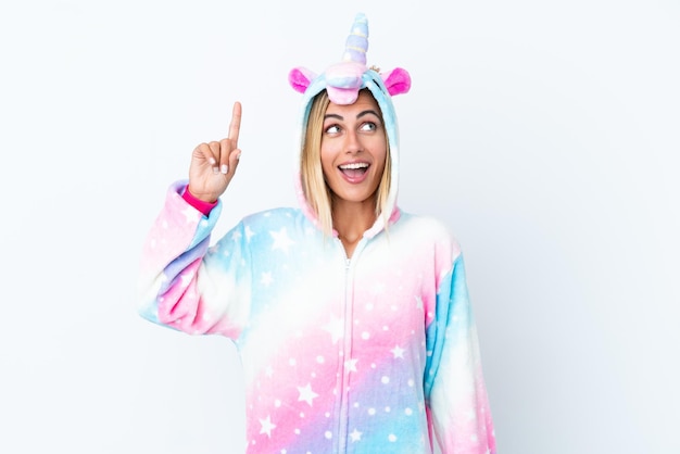 Blonde Uruguayan girl wearing a unicorn pajama isolated on white background intending to realizes the solution while lifting a finger up