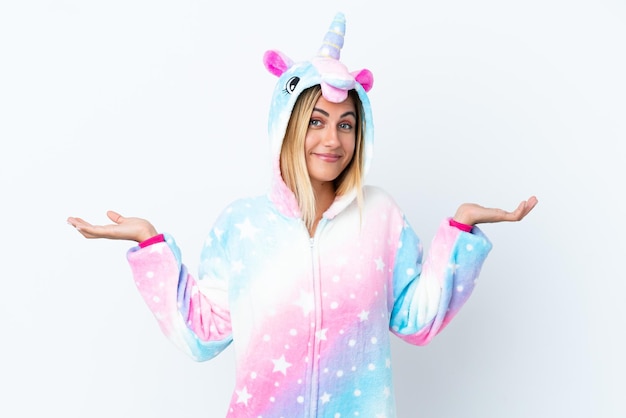 Blonde Uruguayan girl wearing a unicorn pajama isolated on white background with shocked facial expression