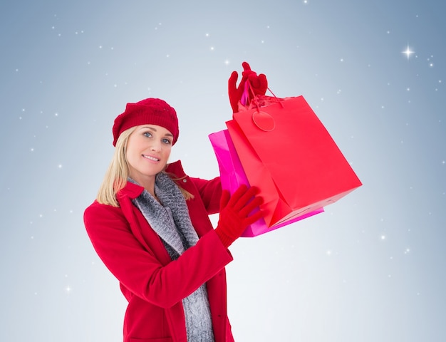 Blonde in winter clothes holding shopping bags