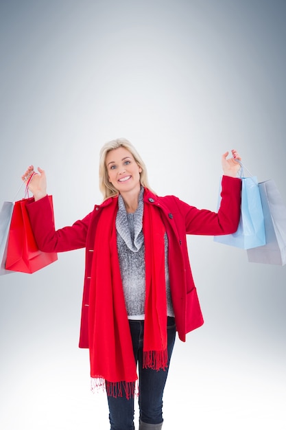 Blonde in winter clothes holding shopping bags