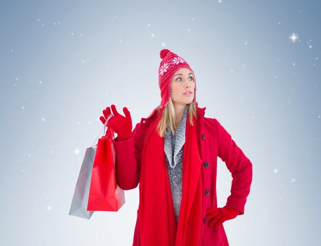 Blonde in winter clothes holding shopping bags