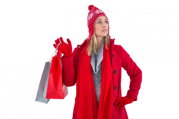 Blonde in winter clothes holding shopping bags