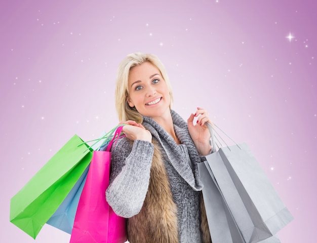 Blonde in winter clothes holding shopping bags