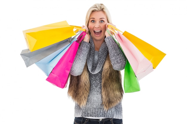 Blonde in winter clothes holding shopping bags