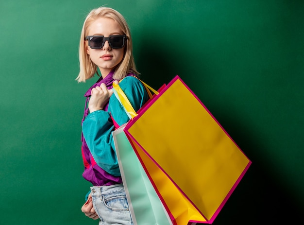 Blonde woman in 90s style jacket with shopping bags