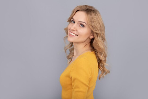 Blonde woman blond woman portrait express positive emotions smooth face skin happy lady with curly hair fashion and beauty female fashion model pretty look of young smiling girl copy space