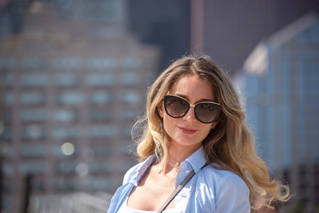 Blonde woman in blue shirt posing