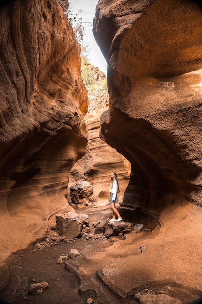 Blonde woman in the canyon of Barranco de las Vacas in Gran Canaria