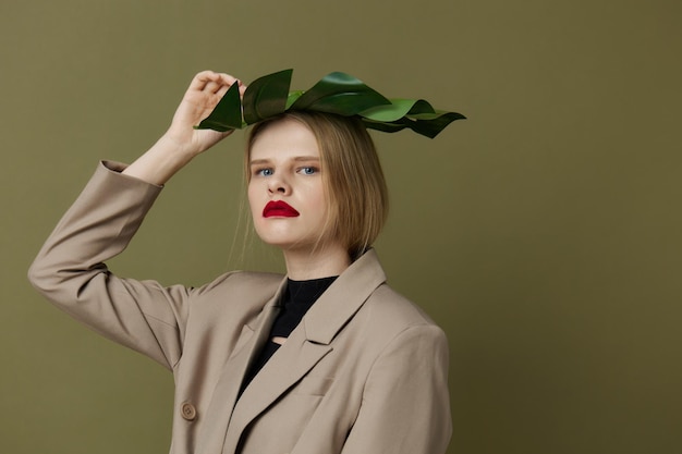 Blonde woman in coat red lips fashion palm leaf studio model unaltered