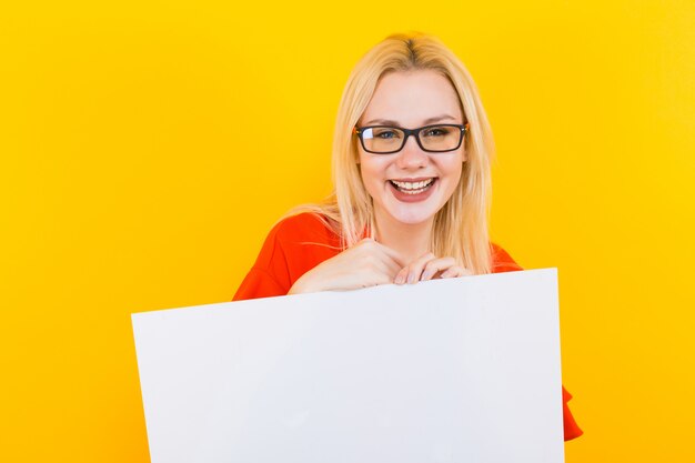 Blonde woman in dress with blank paper