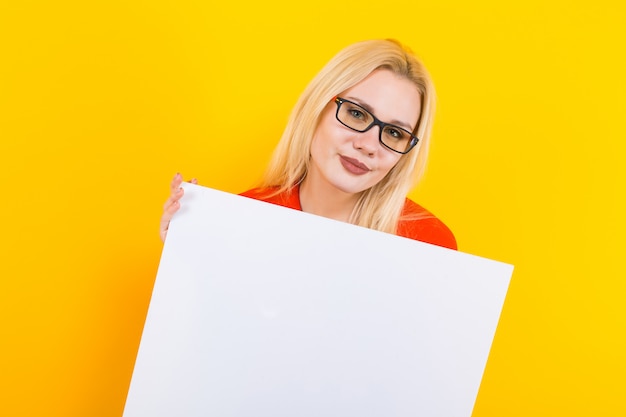 Blonde woman in dress with blank paper