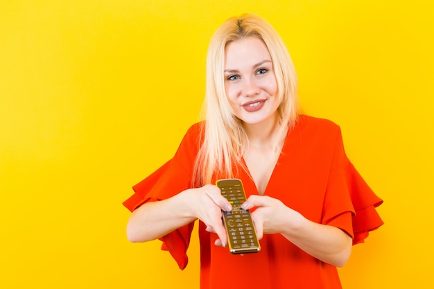 Blonde woman in dress with remote control