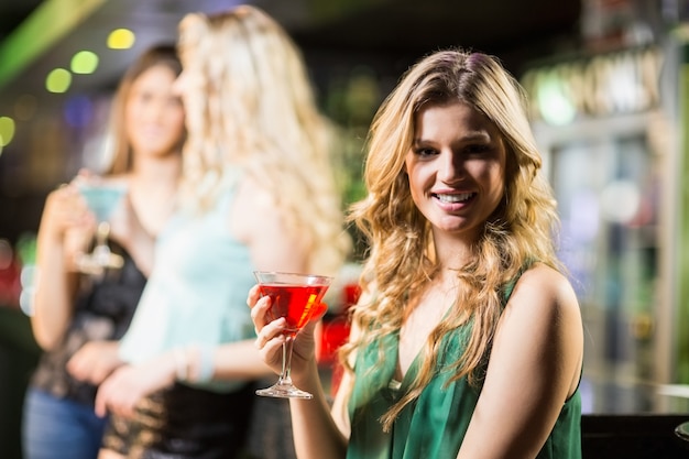 Blonde woman drinking cocktail