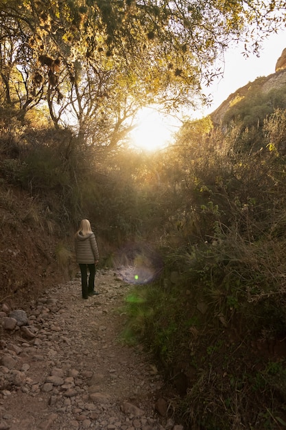 Blonde woman enjoying nature walking on a sunny day