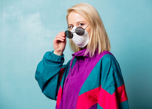 Blonde woman in face mask and 90s style clothes