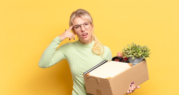 Blonde woman feeling confused and puzzled, showing you are insane, crazy or out of your mind