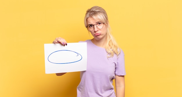 Blonde woman feeling sad and whiney with an unhappy look, crying with a negative and frustrated attitude