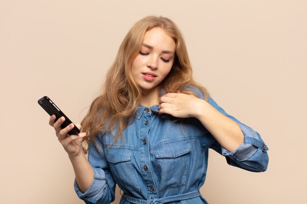 Blonde woman feeling stressed, anxious, tired and frustrated, pulling shirt neck, looking frustrated with problem