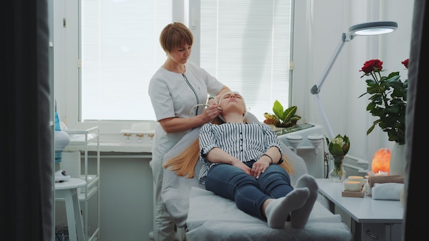 Blonde woman getting microdermabrasion at beauty salon