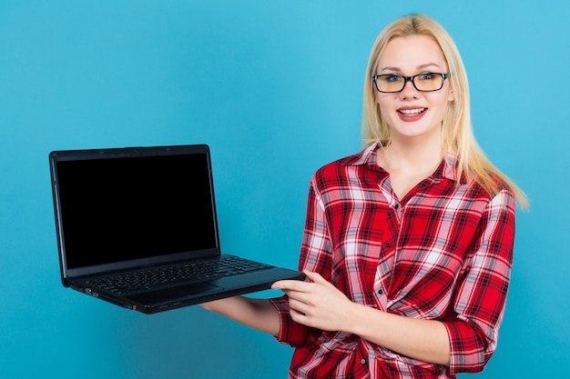 Blonde woman in glasses hold laptop