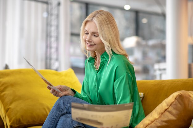 Blonde woman in a green blouse feeling interested