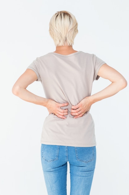 blonde woman having a back ache and holding her back