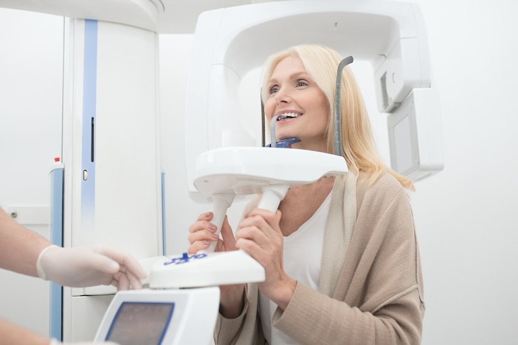 A blonde woman having dental treatment and feeling positive