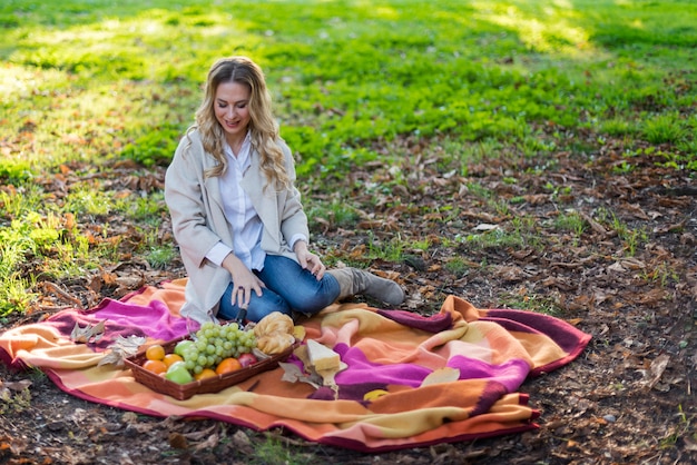 Blonde woman having a picnic at the park