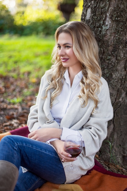 Blonde woman having a picnic at the park