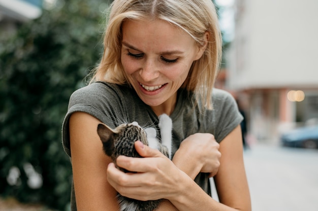 Blonde woman holding cute little cat