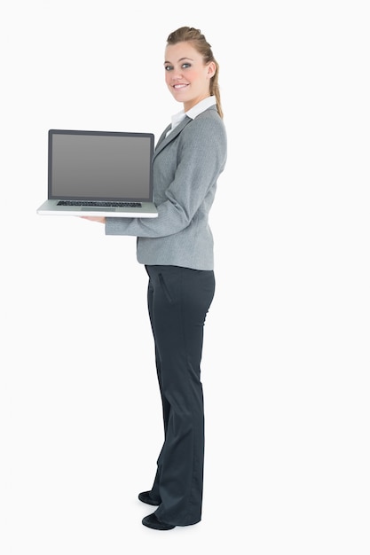 Blonde woman holding a laptop