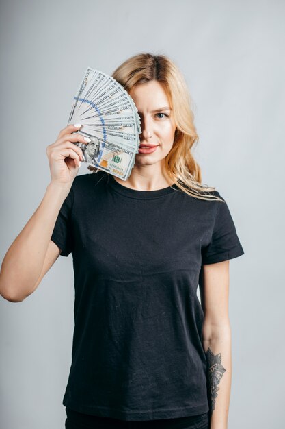 Blonde woman holding lots of money
