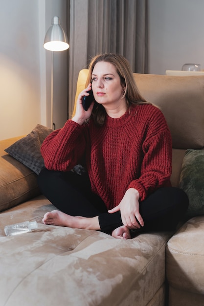 Blonde woman at home talking by phone