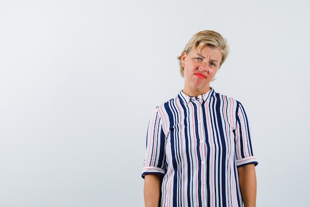 The blonde woman is feeling sad on white background