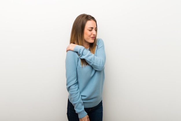 Blonde woman on isolated white background suffering from pain in shoulder for having made an effort