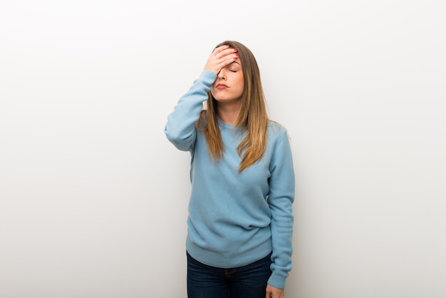 Blonde woman on isolated white background with surprise and shocked facial expression