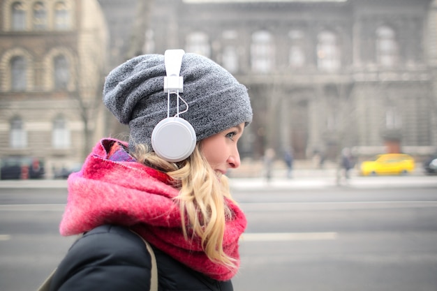 Blonde woman listening to music on headphones