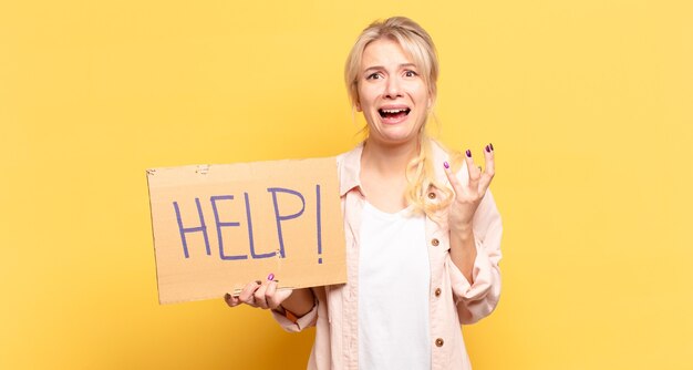 Photo blonde woman looking desperate and frustrated, stressed, unhappy and annoyed, shouting and screaming