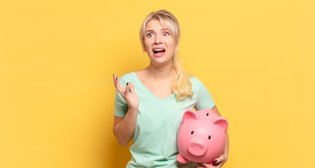 Blonde woman looking desperate and frustrated, stressed, unhappy and annoyed, shouting and screaming