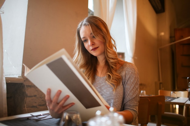 Blonde woman looking at the menu