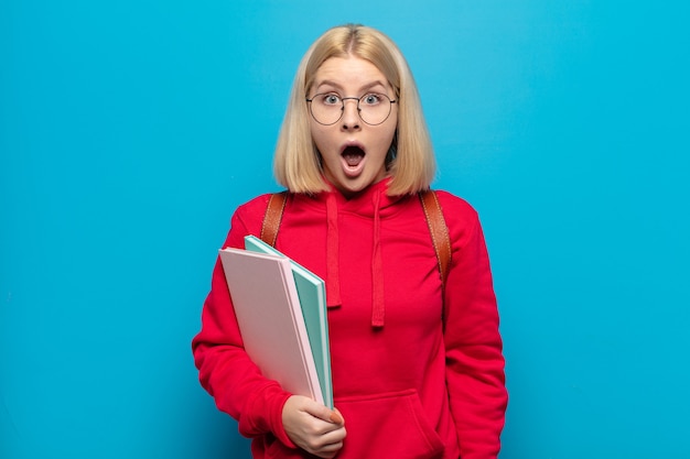 Blonde woman looking very shocked or surprised, staring with open mouth saying wow