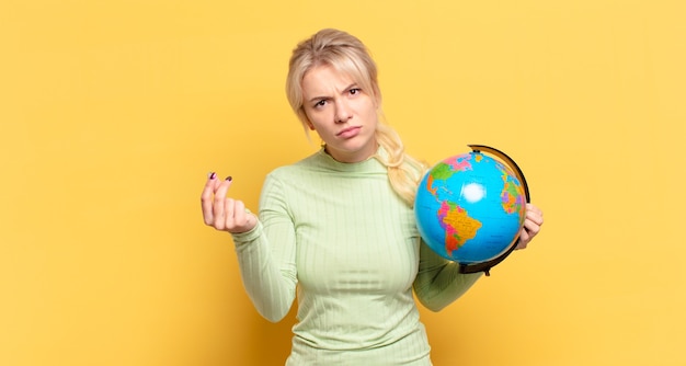 Blonde woman making capice or money gesture, telling you to pay your debts!