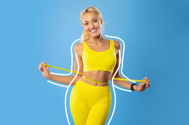 Blonde woman measuring waist sharing weight loss result being happy over slimming process keeping