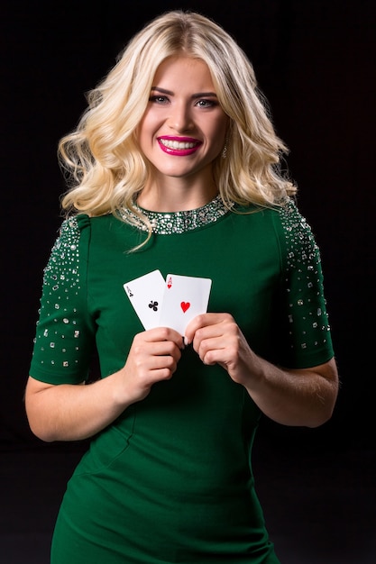 Blonde woman in posing with cards for gambling