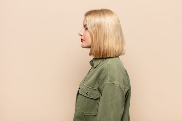 Blonde woman on profile view looking to copy space